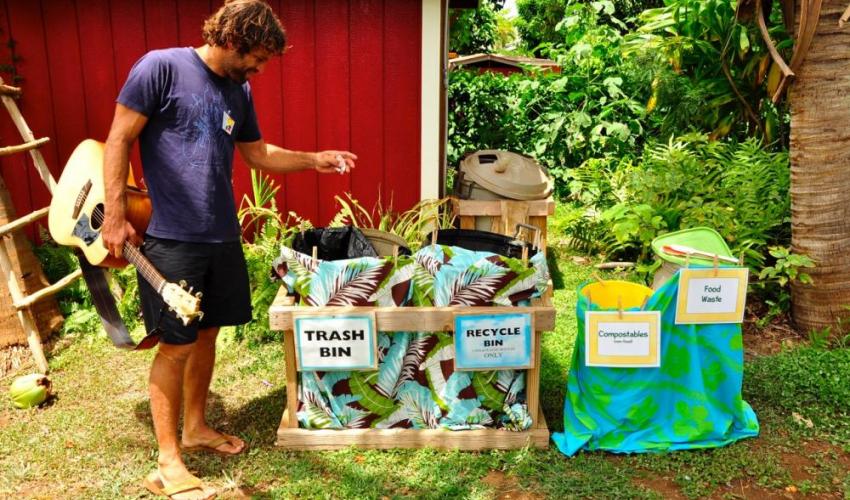 Kōkua Hawaiʻi founder Jack Johnson sorting waste 